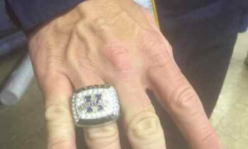 Hartland wrestling coach Todd Cheney shows off his championship ring after Wednesday's ceremony. (Photo by Tim Robinson)