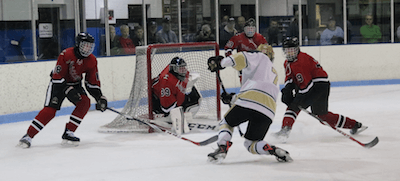 Howell's Josh Seiter takes a shot in the first period Friday. He later scored what turned out to be the game-winning goal in Howell's 9-1 win over Pinckney. (Photo by Tim Robinson)
